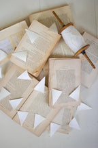 White Paper Flag Garland On Wood Spool